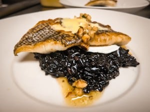 whiskey cake, seared black bass over creamy black-rice risotto then accessorized with brown butter-hazelnut vinaigrette and a drizzle of orange sabayon