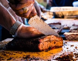 Justin Fourton carving a brisket