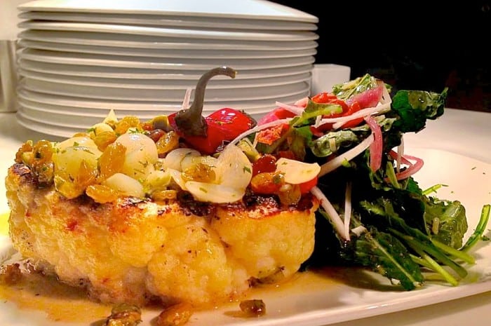 Wow-- at Dish Restaurant, chef Garreth Dickey's grilled cauliflower steak with cipollini onions, baby kale, Calabrese peppers, black radish, golden raisins and brown butter is a vegetarian stunner.